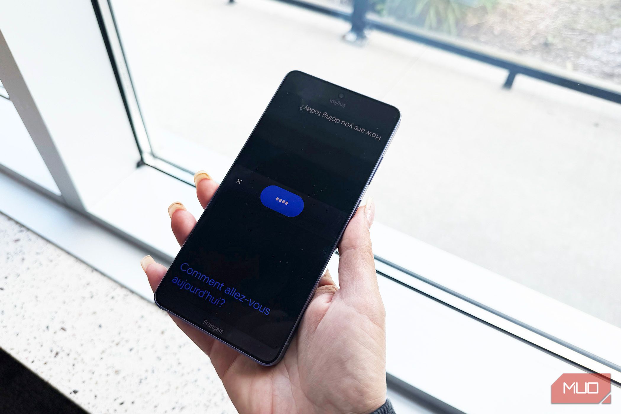 A face to face conversation happening in Google Translate on a phone.