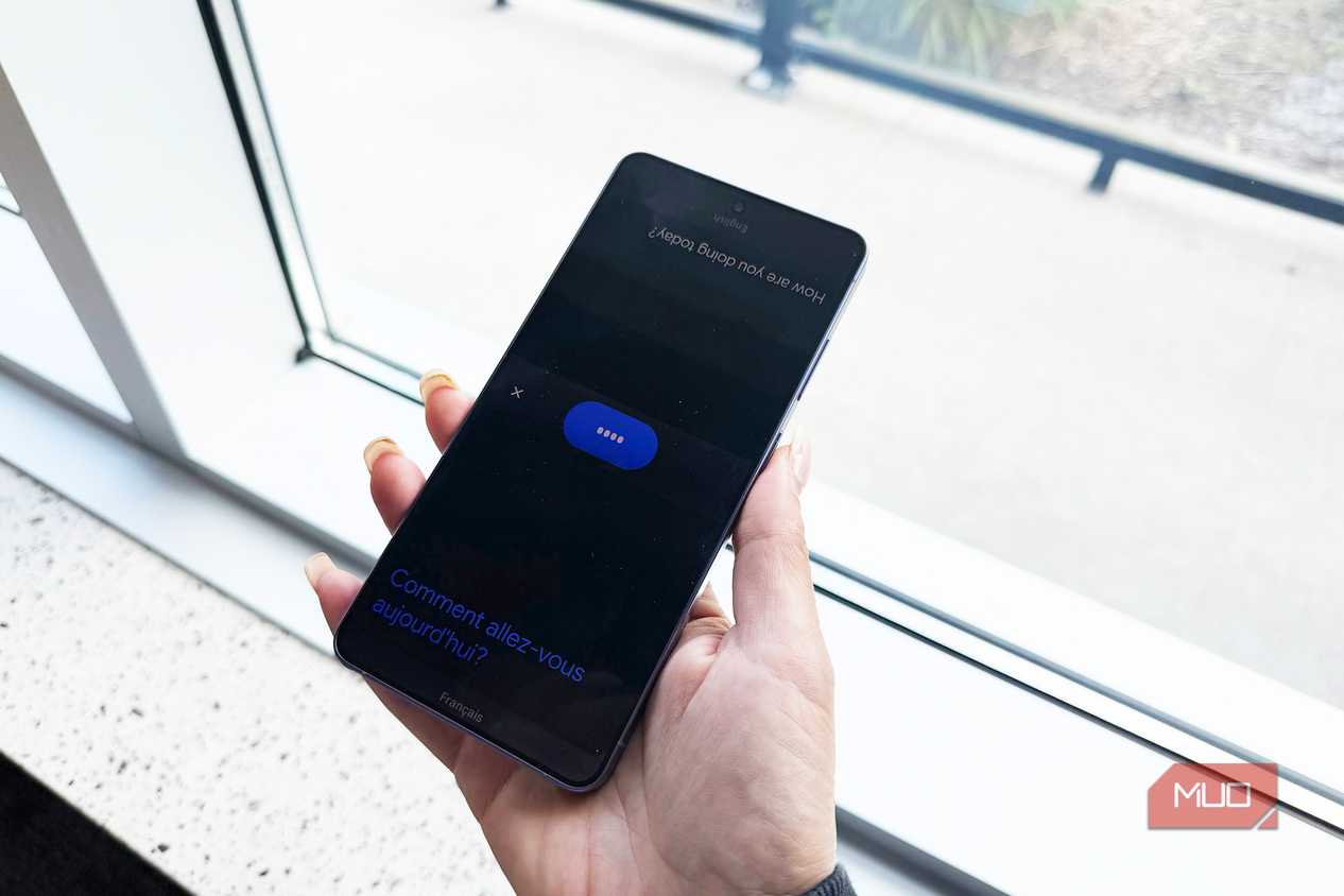 A face to face conversation happening in Google Translate on a phone.