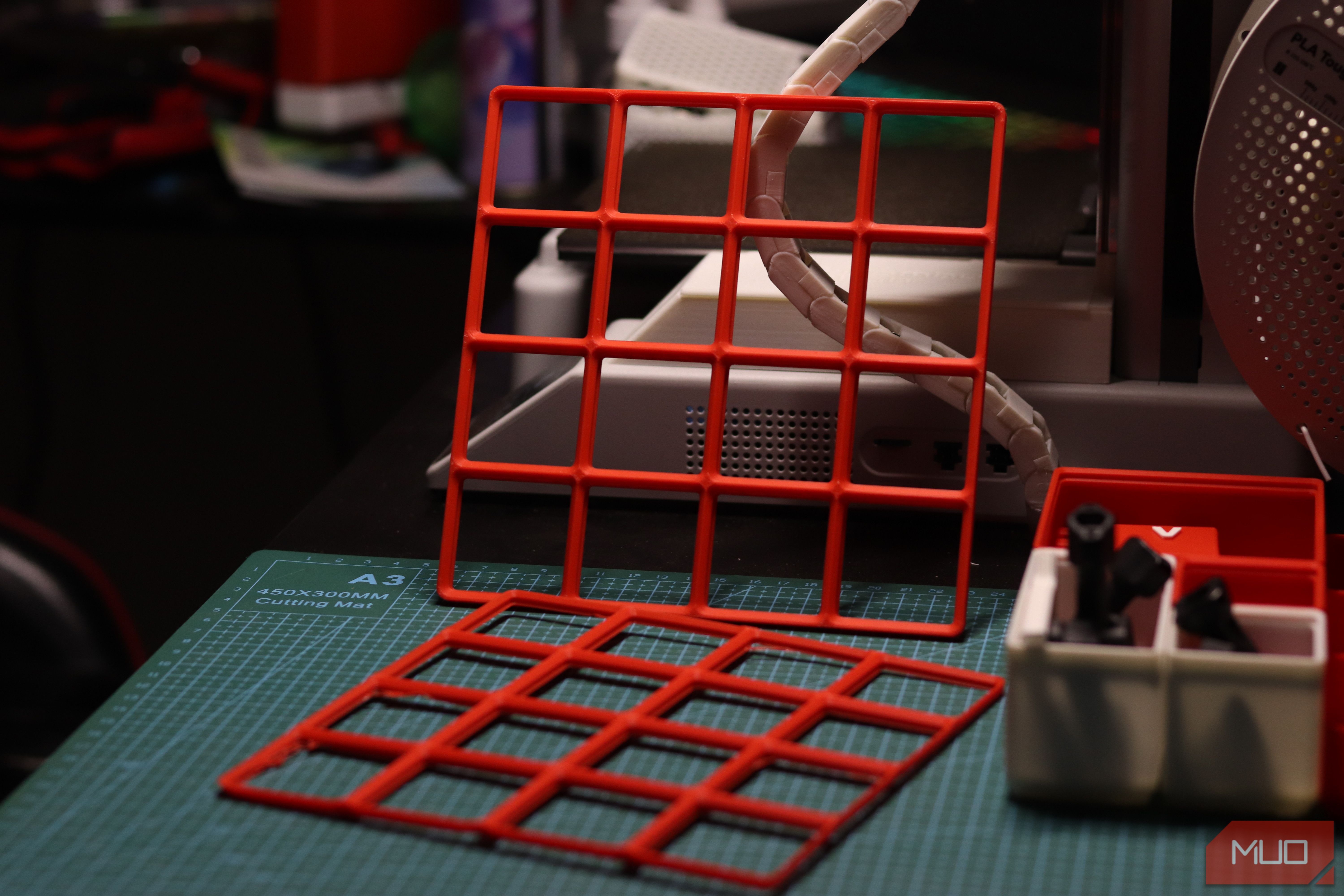 Gridfinity baseplates with 3D printer in the background.