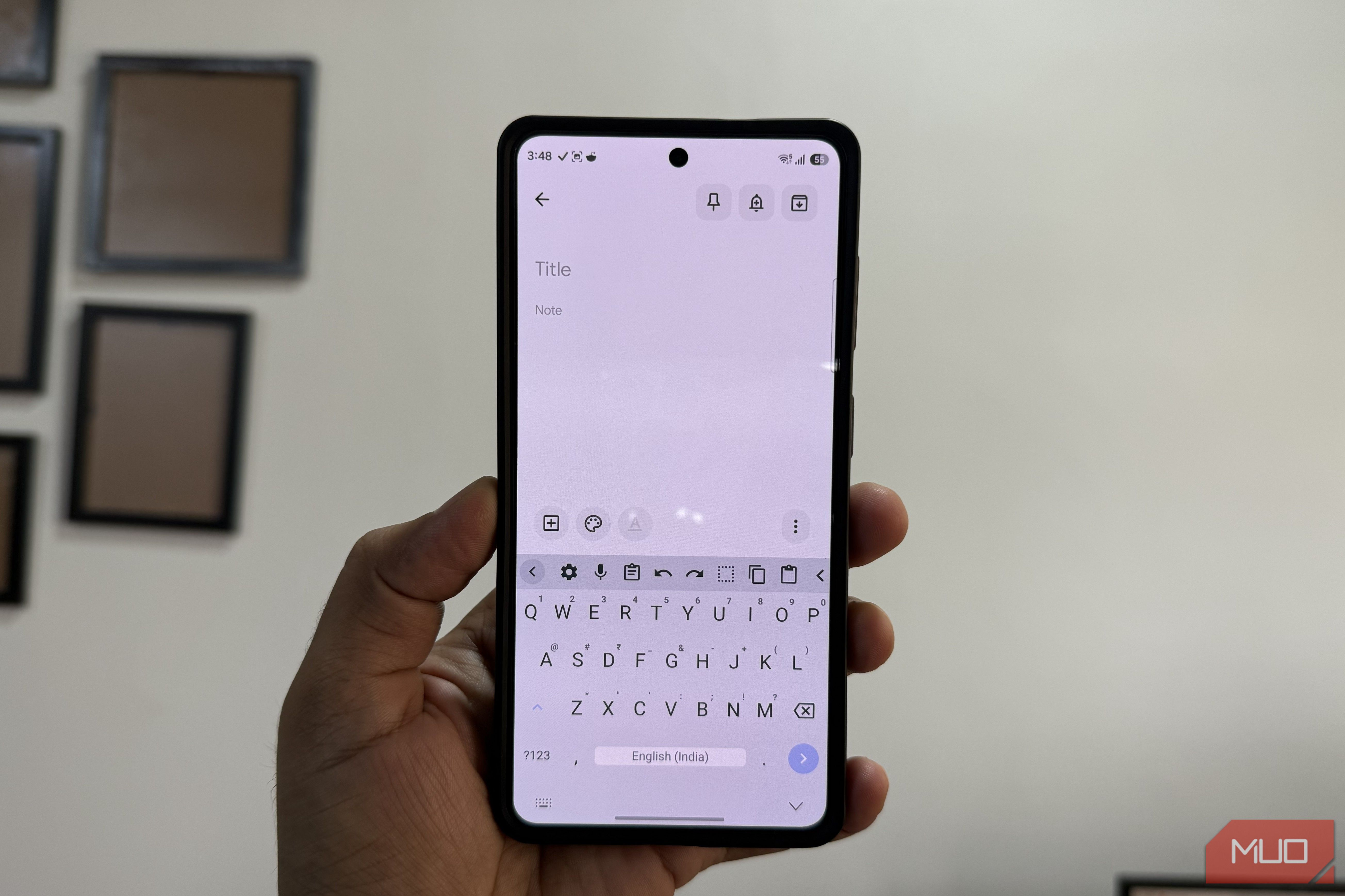 HeliBoard keyboard open on Samsung phone in hand