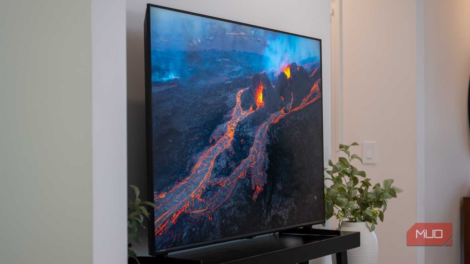 The Hisense U6SF Pro displaying a dramatic aerial view of glowing orange lava flows from an active volcano.