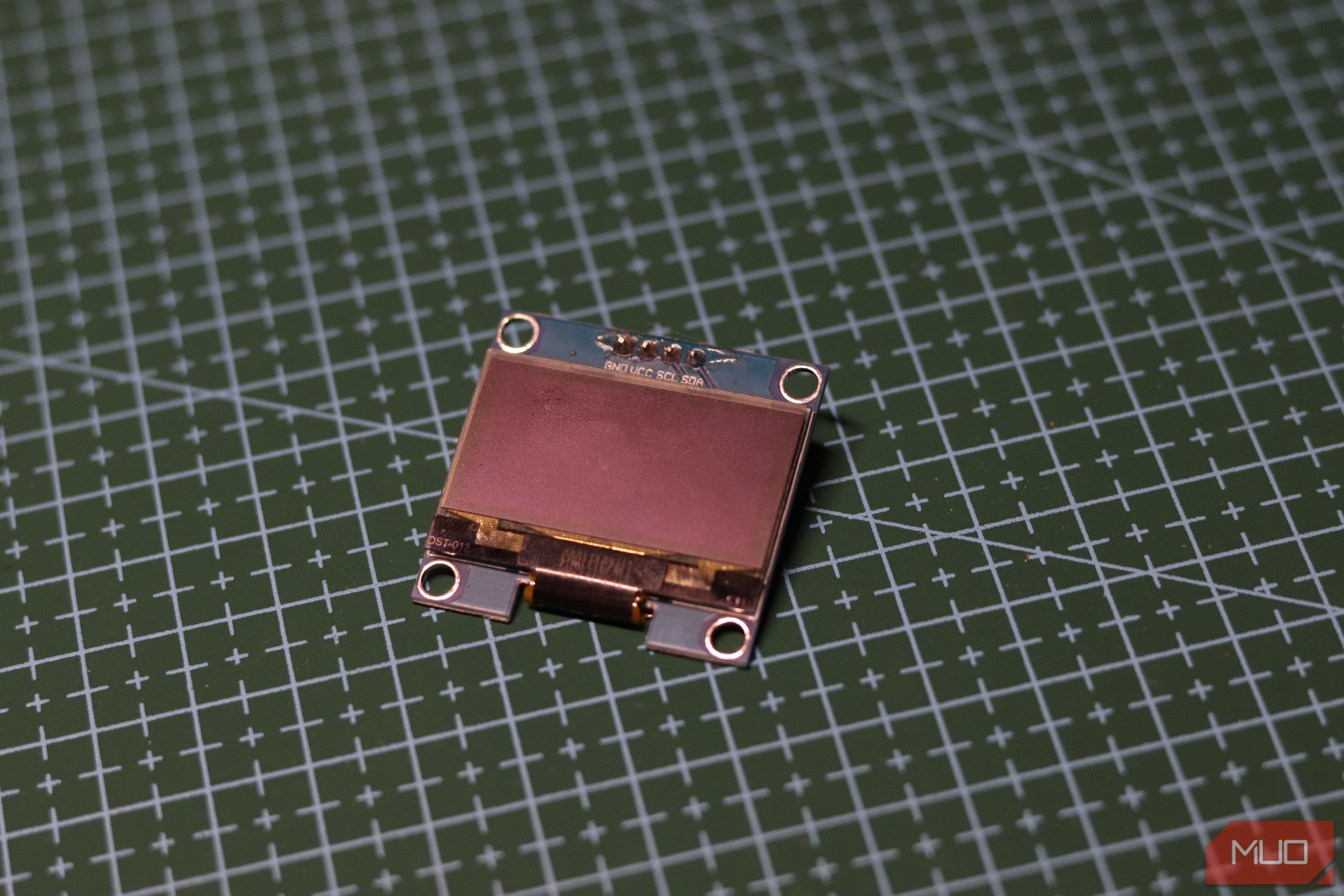 I2C OLED display on green mat.