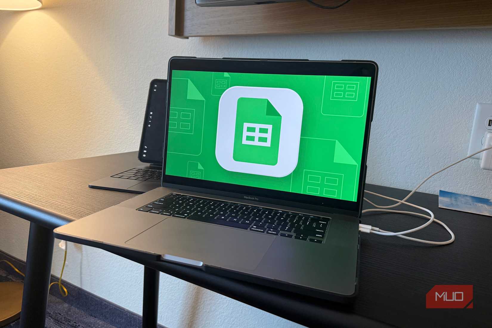 intel macbook pro with google sheets logo on screen