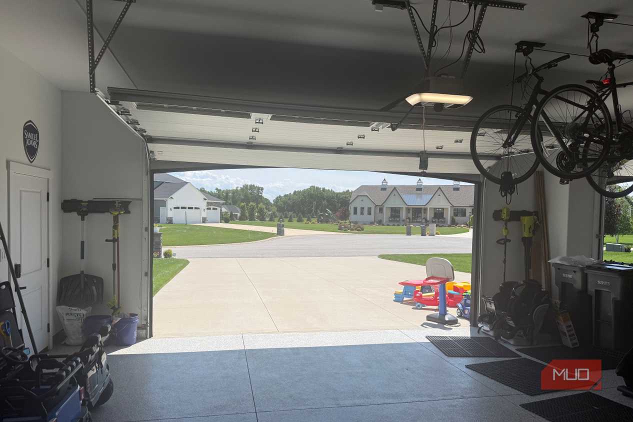 interior garage looking out open door with ceiling bikes and kids toys