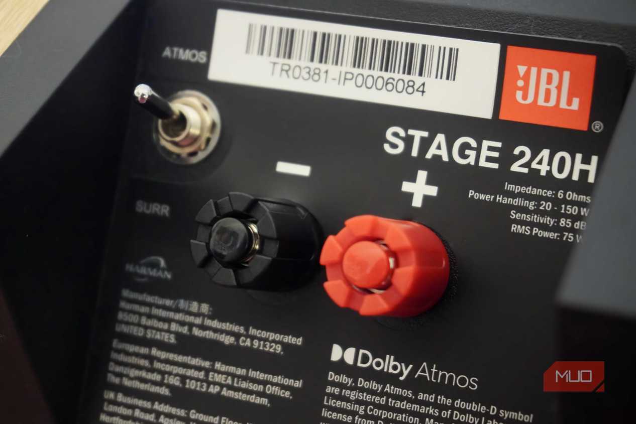 The switch and binding posts on the back of a set of Dolby Atmos speakers.