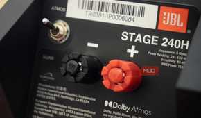 The switch and binding posts on the back of a set of Dolby Atmos speakers.