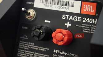 The switch and binding posts on the back of a set of Dolby Atmos speakers.