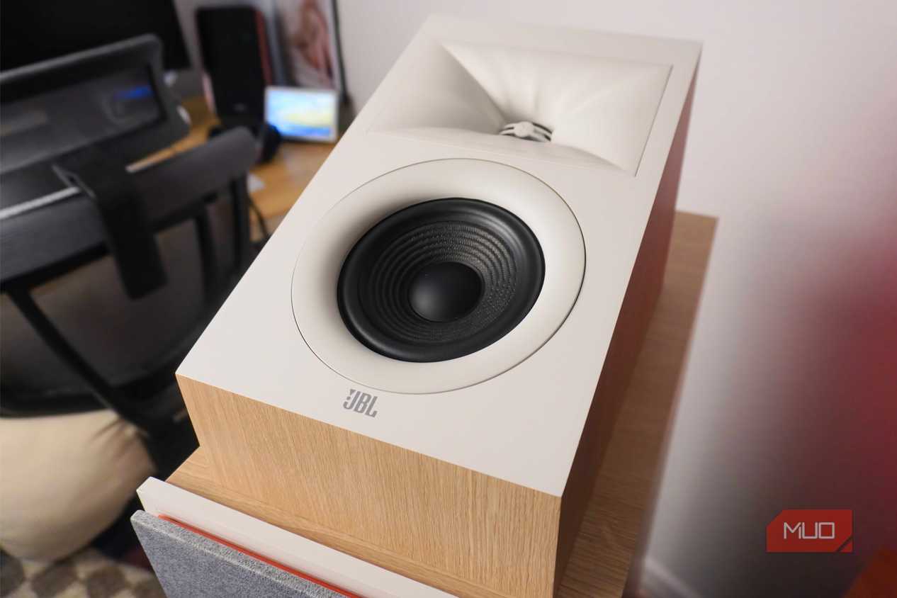 The JBL Stage2 Dolby Atmos speakers on top of floorstanding speakers.