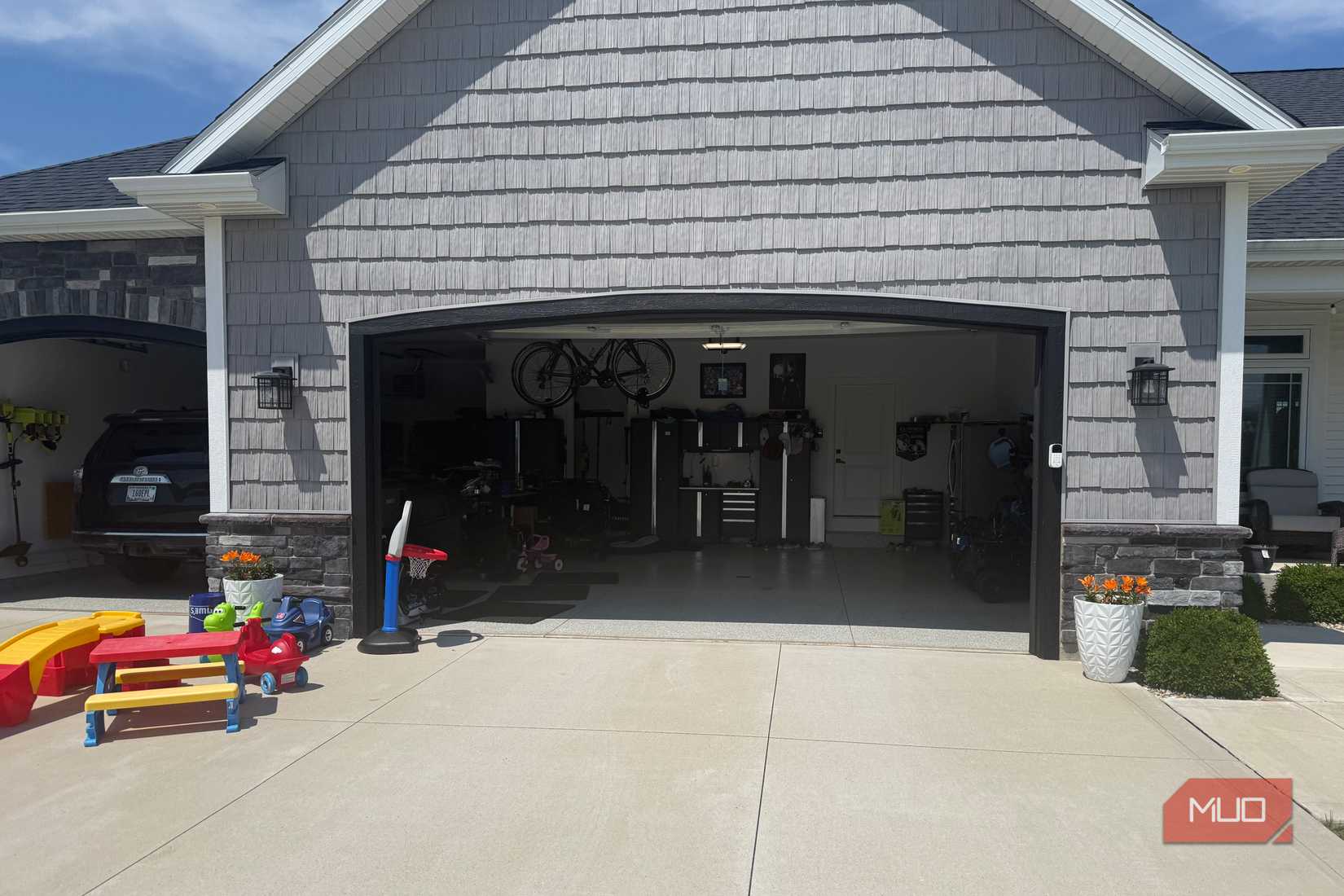 open double garage with wall mounted bikes and workbench