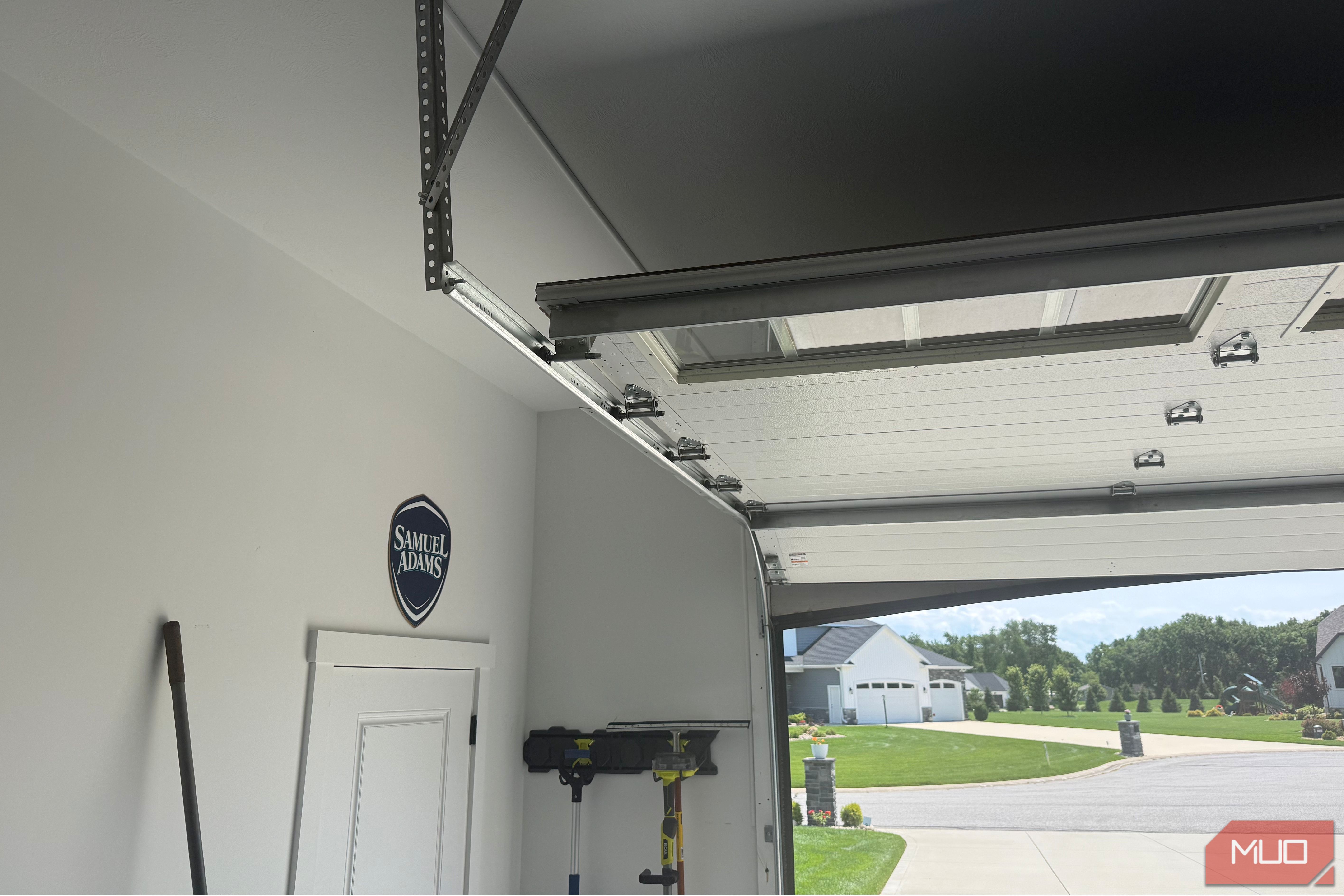 open garage door track with samuel adams sign on wall