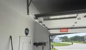 open garage door track with samuel adams sign on wall