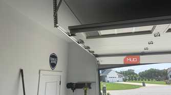open garage door track with samuel adams sign on wall