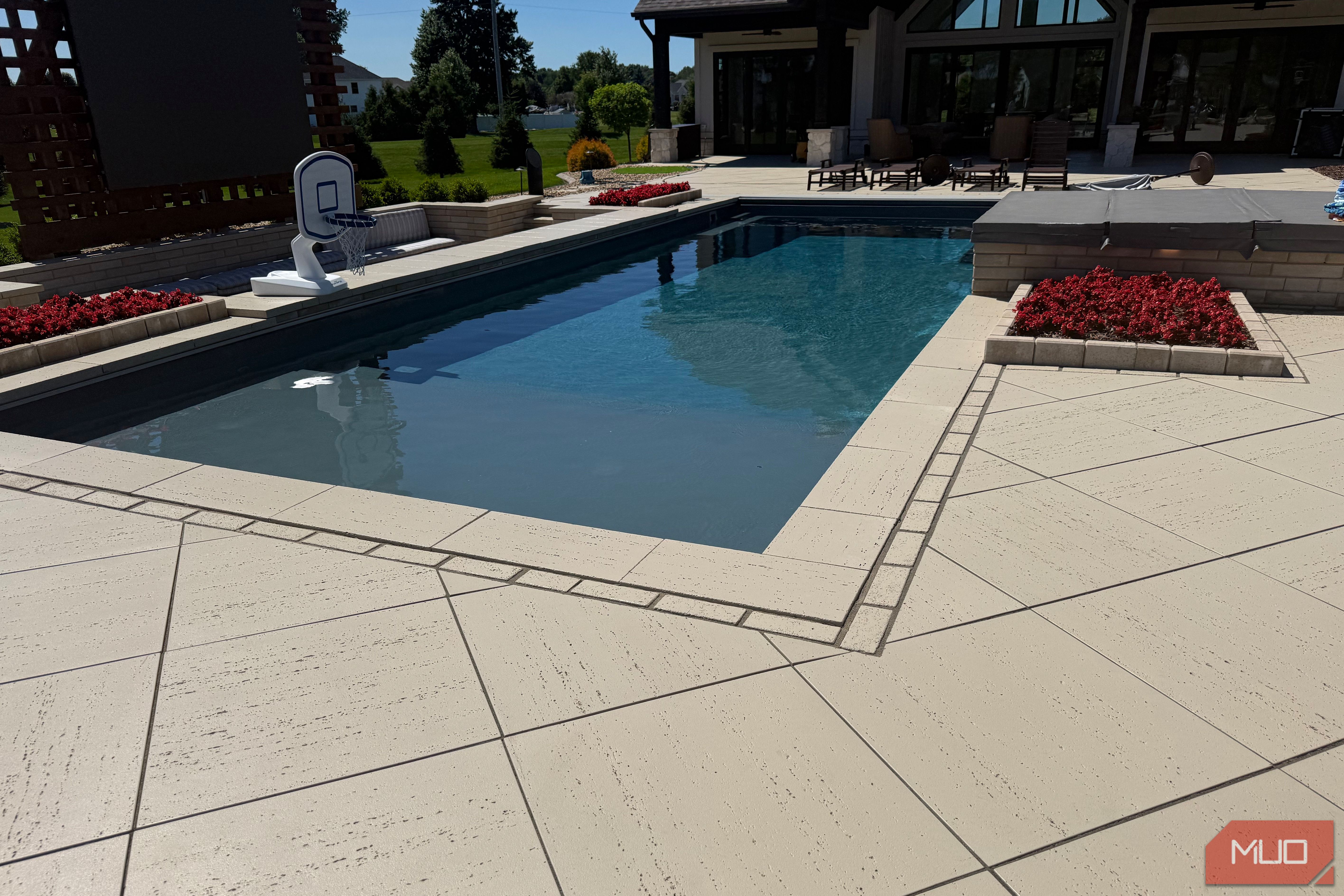 pool corner with red flower planter