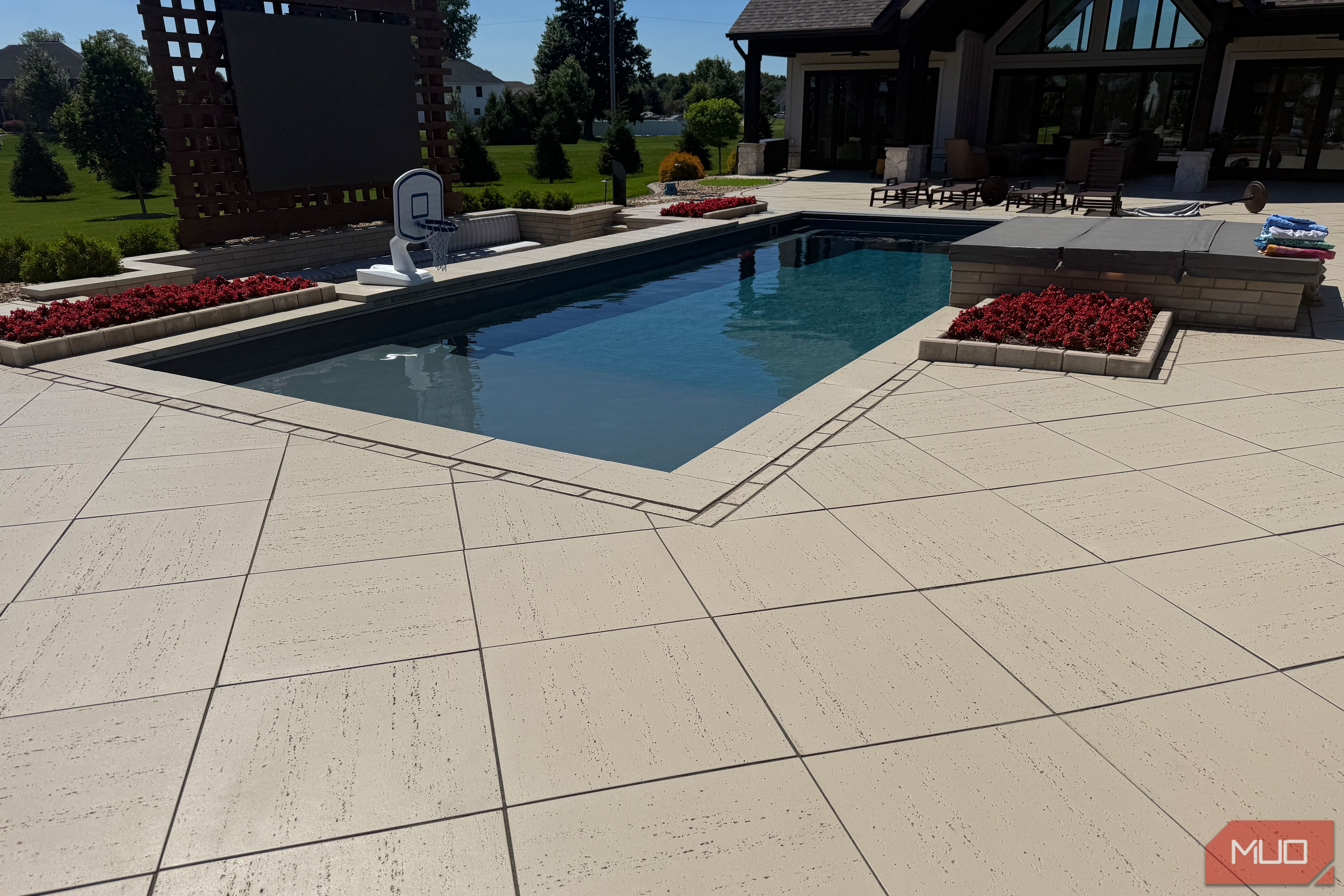 pool with basketball hoop and paver patio