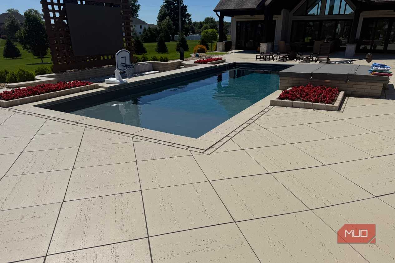pool with basketball hoop and paver patio