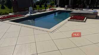 pool with basketball hoop and paver patio