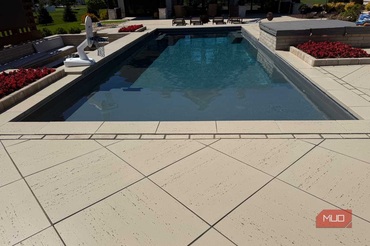 pool with lounge chairs and hot tub