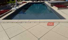 pool with lounge chairs and hot tub