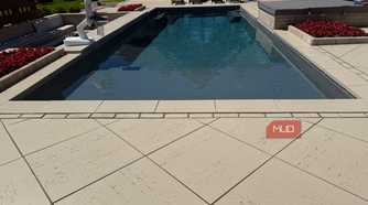 pool with lounge chairs and hot tub