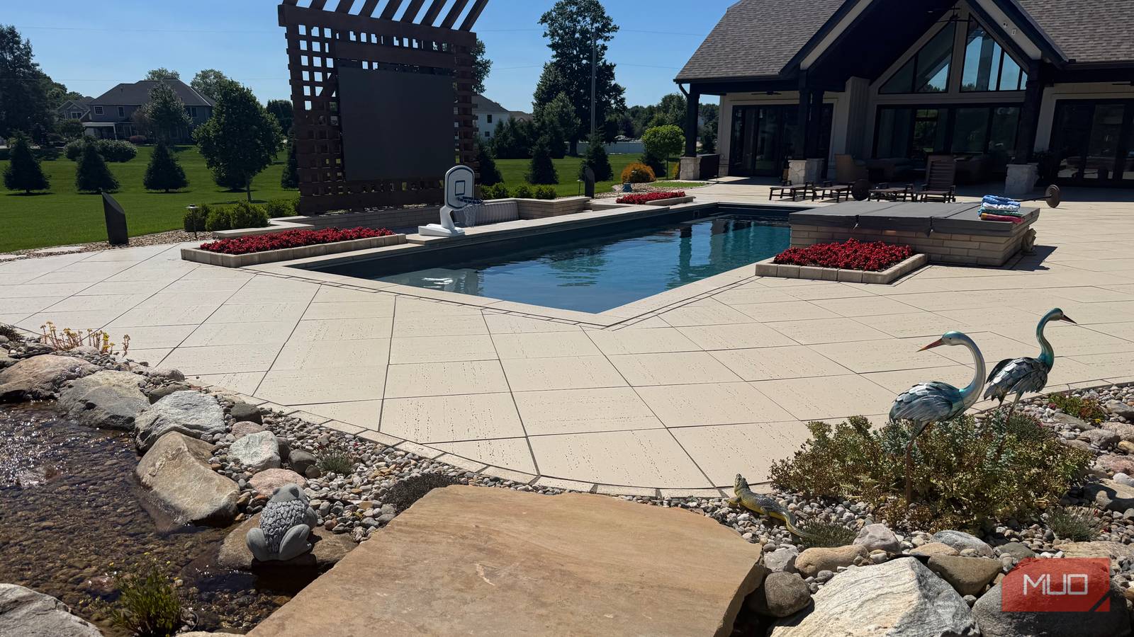 pool with pergola and heron statues