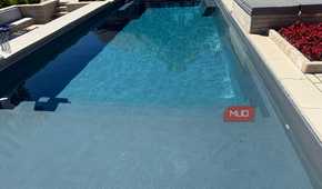 pool with sun shelf and spa