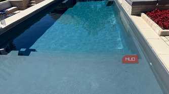 pool with sun shelf and spa