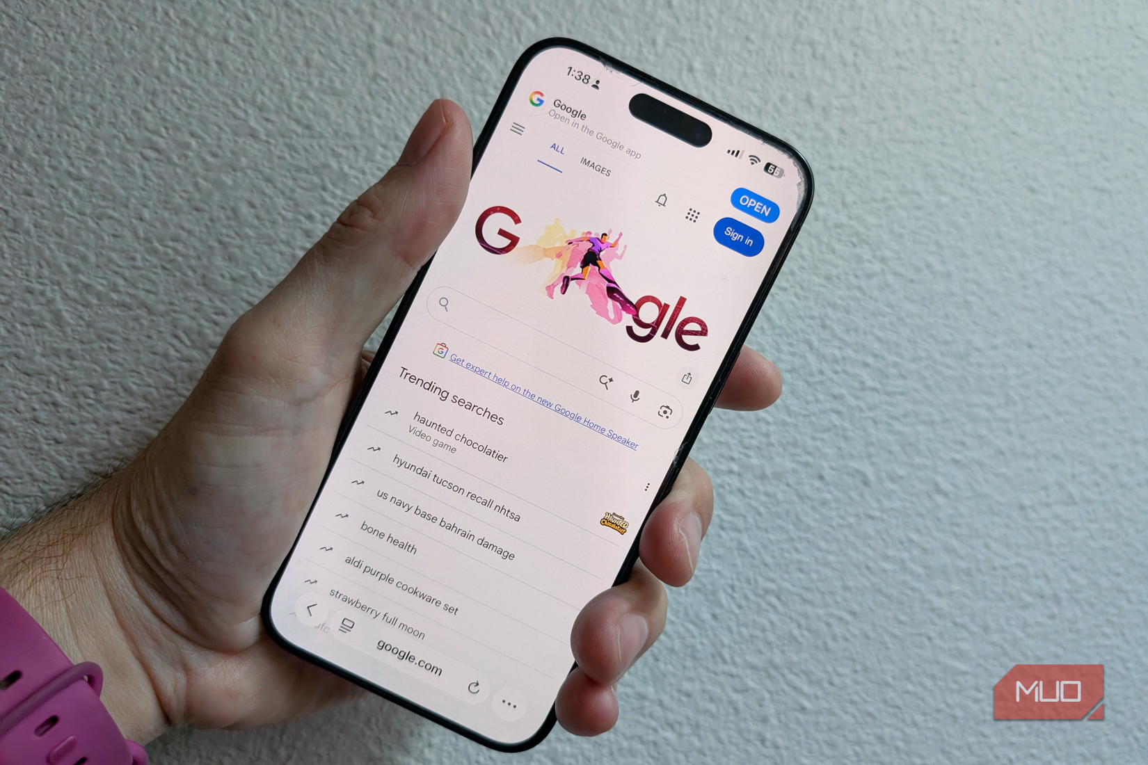 Safari on iPhone screen held in hand