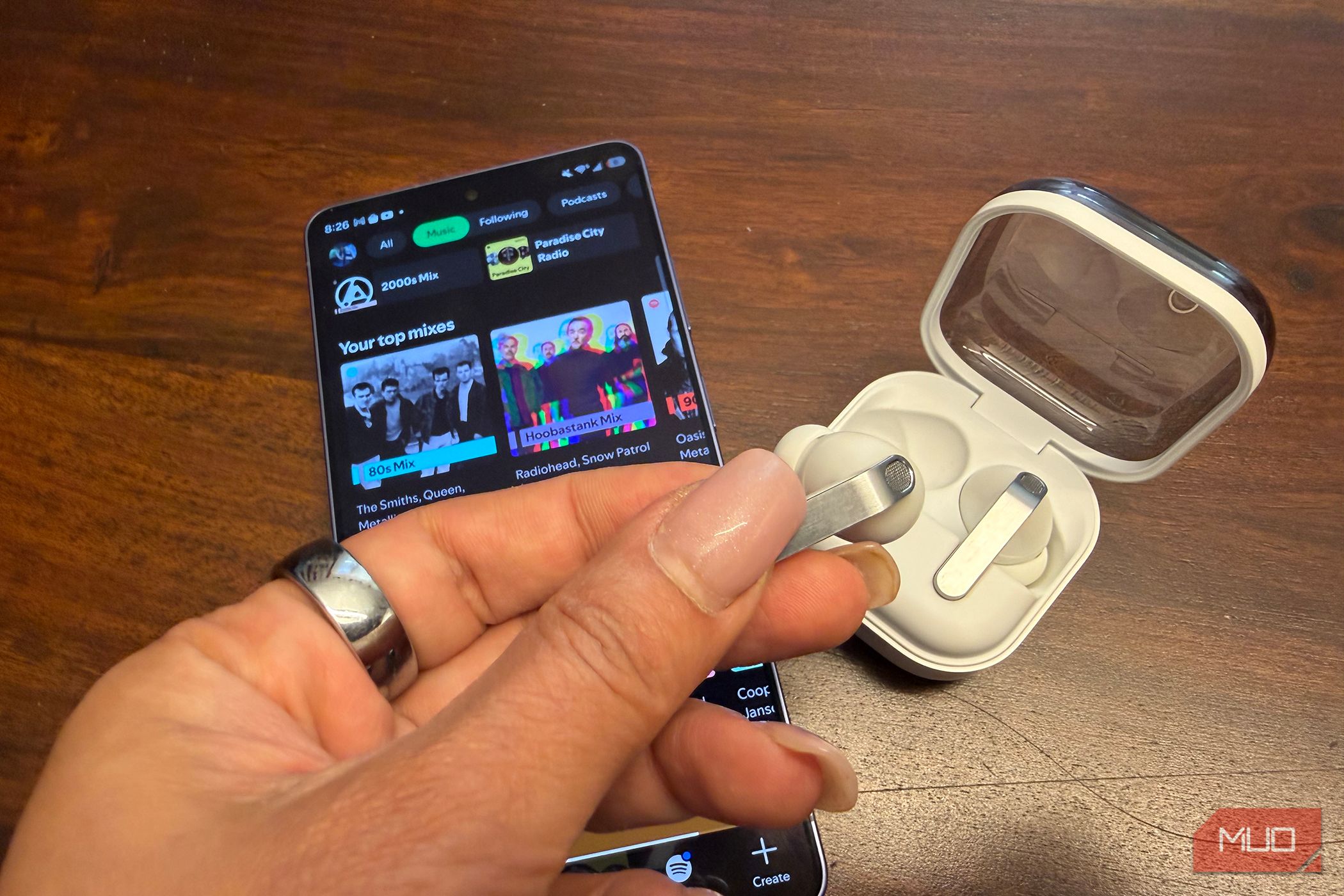 The Samsung Galaxy Buds4 pro with the Samsung Galaxy S26 Ultra showing Spotify.