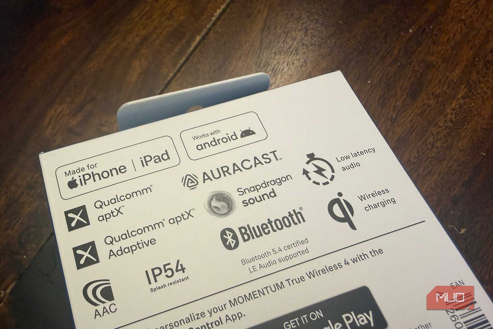 Logos on the back of the box of the Sennheiser Momentum 4 Wireless earbuds.