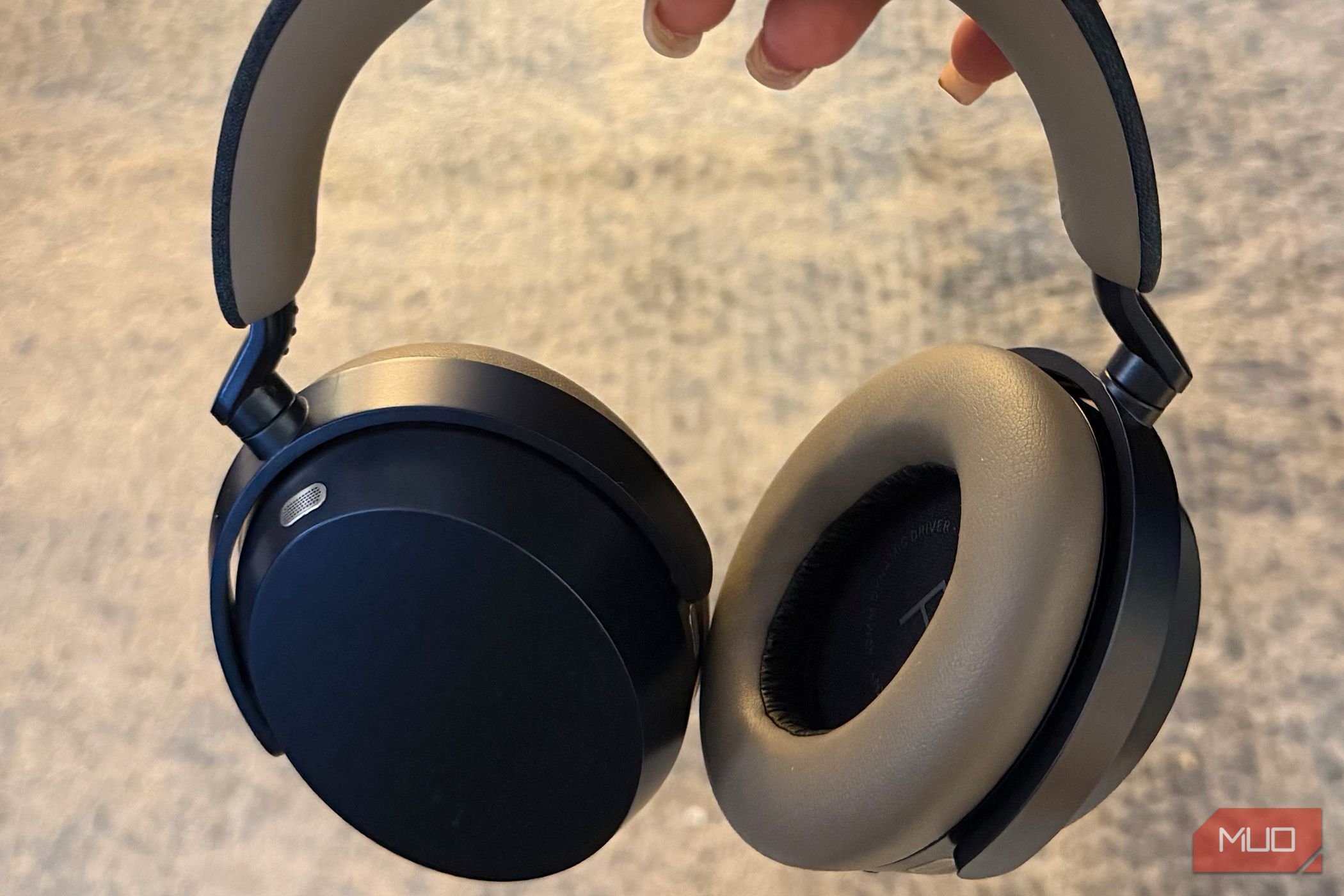 The Sennheisr Momentum 5 headphones held in hand.