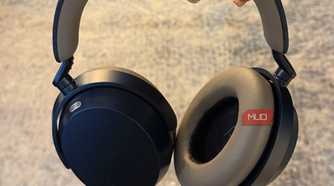 The Sennheisr Momentum 5 headphones held in hand.