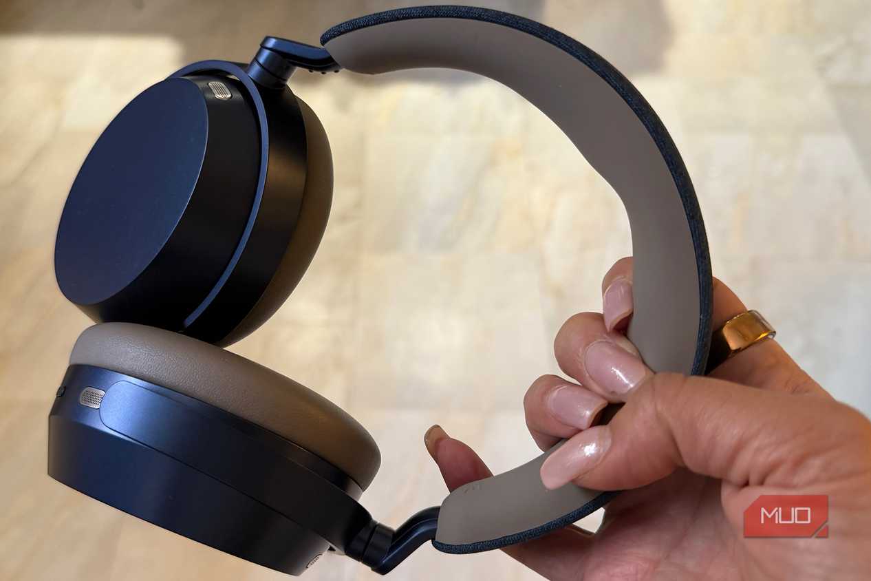 The Sennheiser Momentum 5 headphones held in hand.