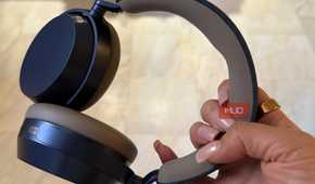 The Sennheiser Momentum 5 headphones held in hand.