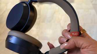 The Sennheiser Momentum 5 headphones held in hand.