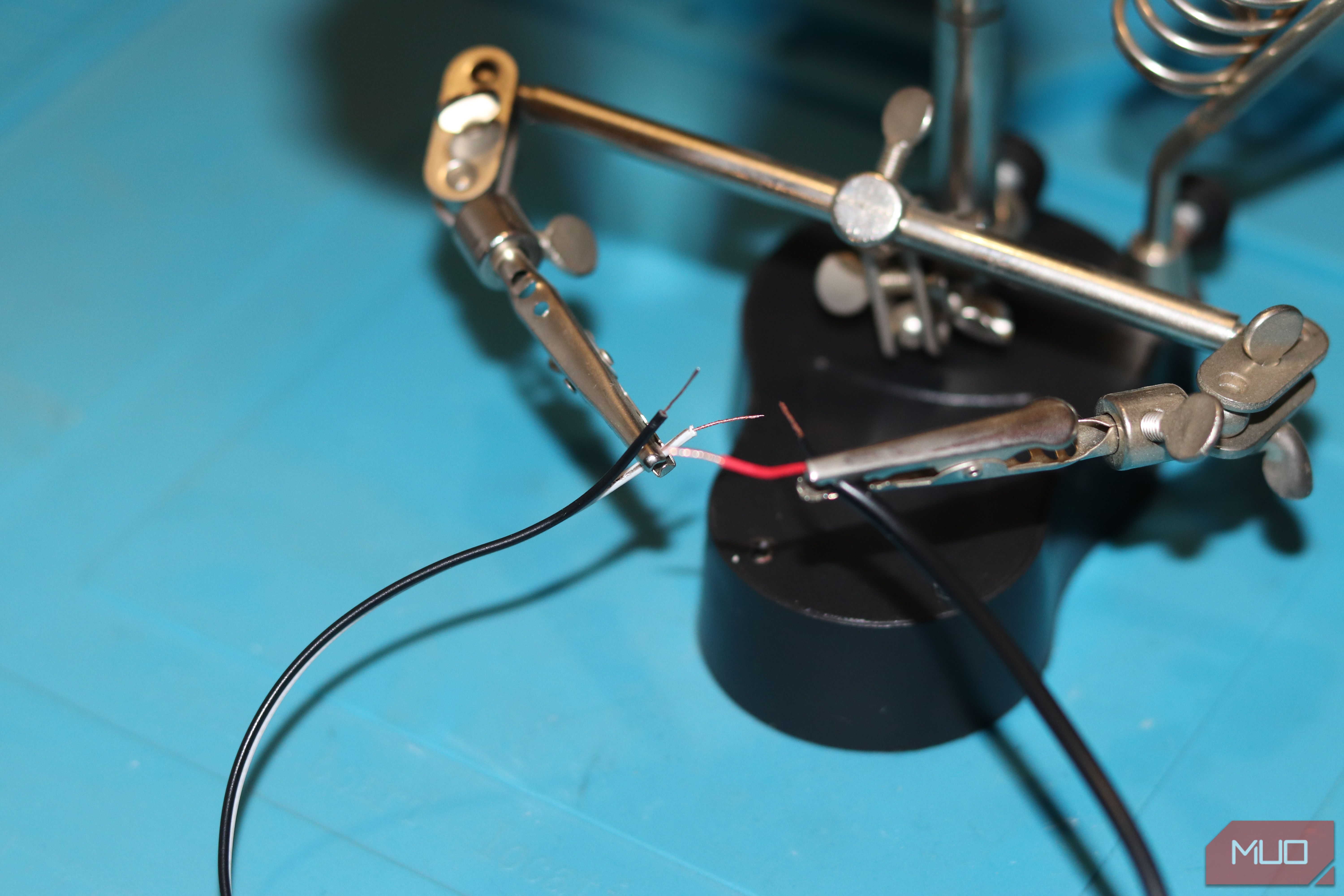 Soldering two cables on a soldering station.