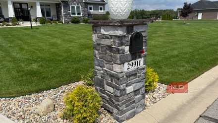 Stone mailbox pillar with house number 29911