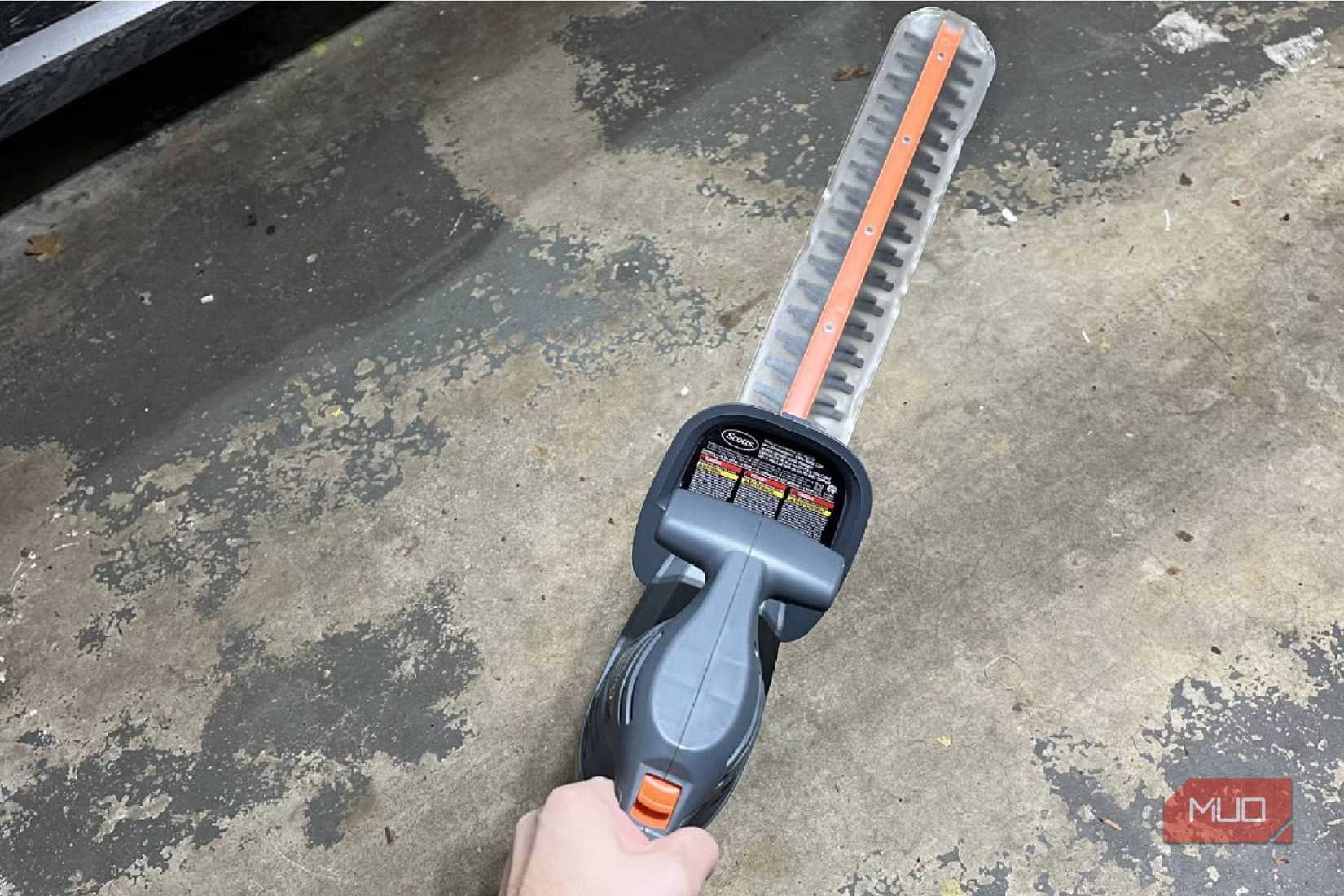 A person holding a Scott's corded hand trimmer