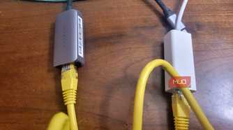 Two ethernet cables plugged into two adapters