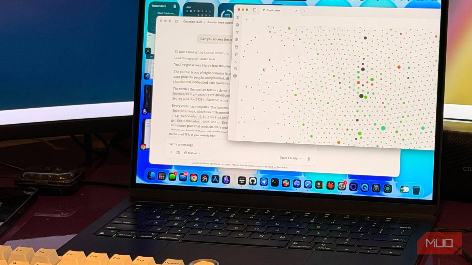 A laptop showing Claude and Obsidian the note-taking app