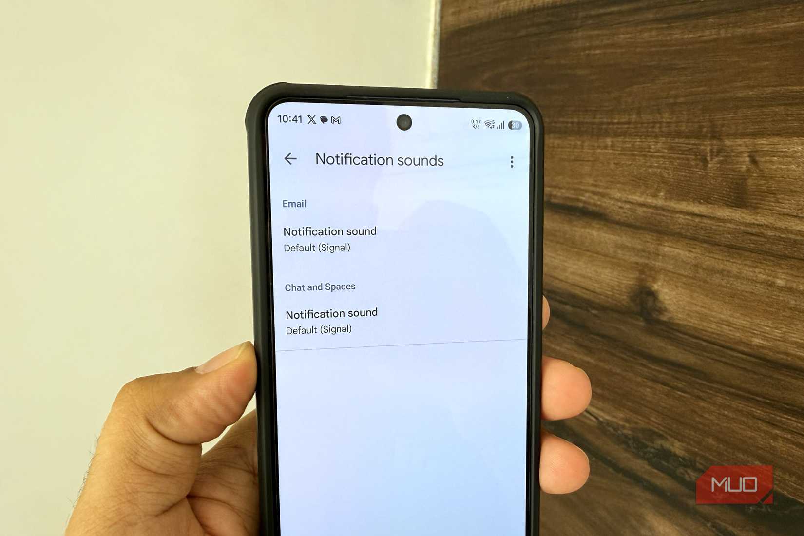 A phone in hand showing Gmail app notification settings