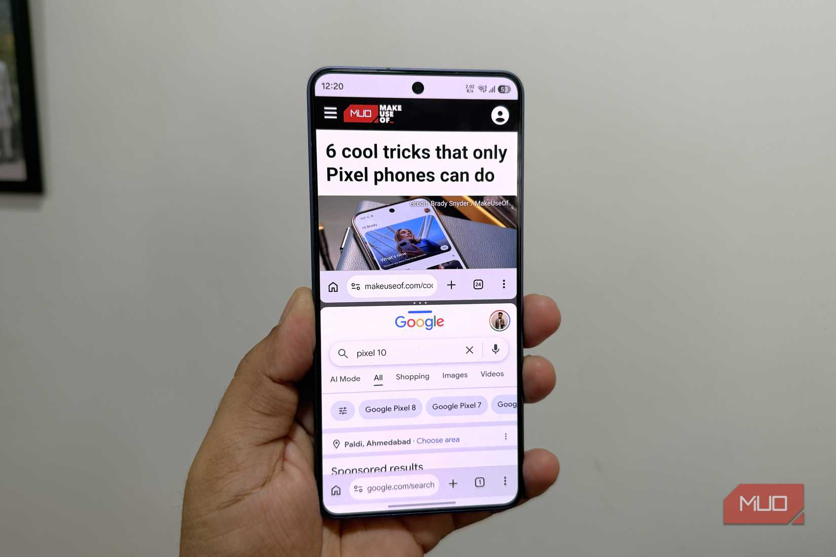 Android phone in hand showing Chrome split screen feature