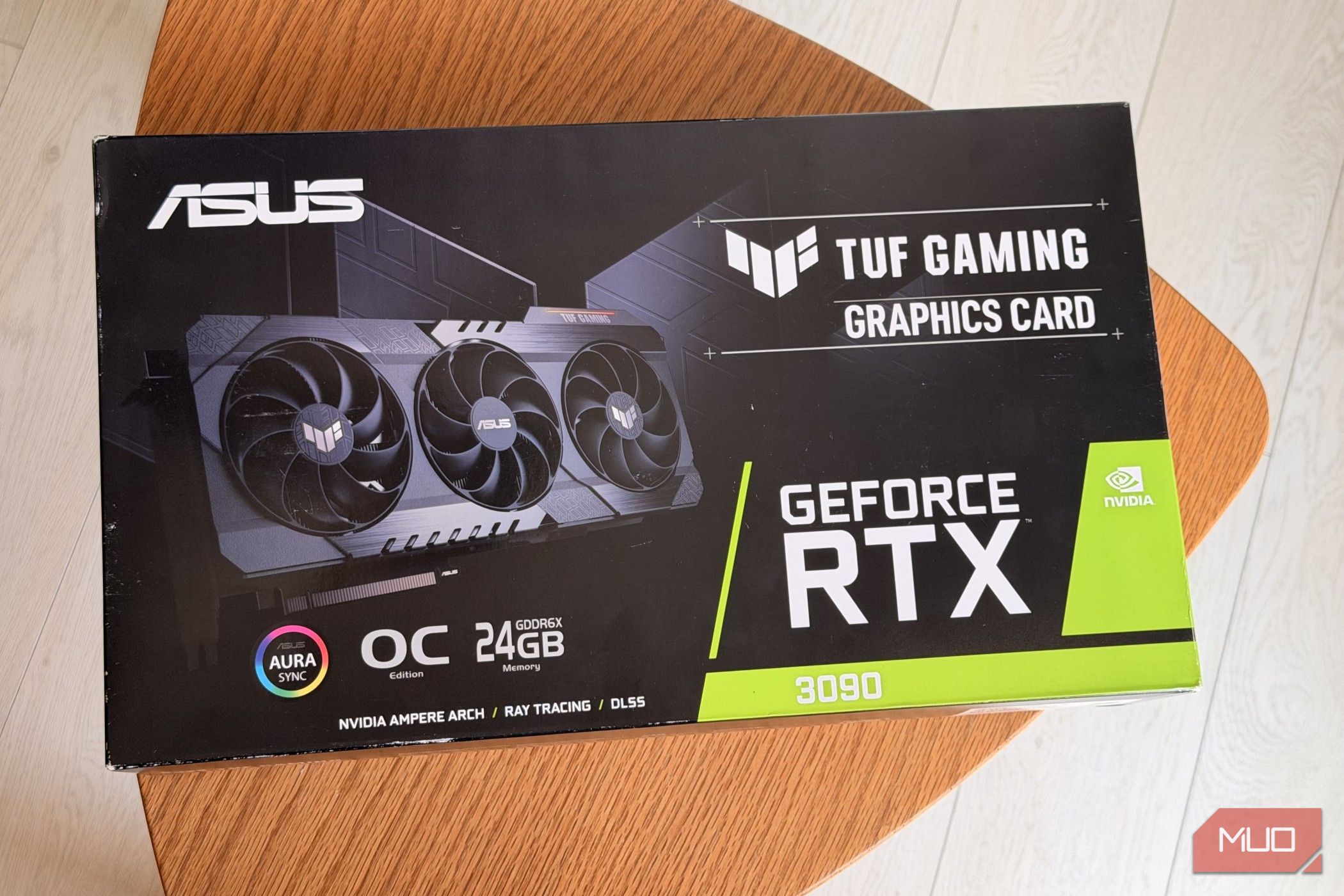 ASUS TUF Gaming GeForce RTX 3090 graphics card box on a round wooden table
