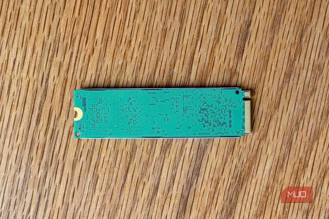 Back of an M.2 NVMe SSD circuit board on a wooden desk