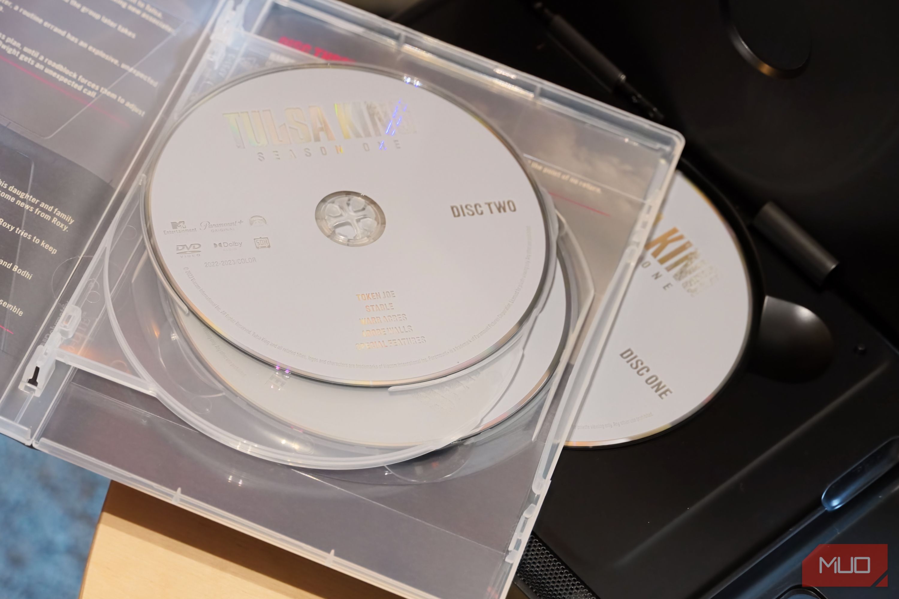 A pile of DVD discs on a player.