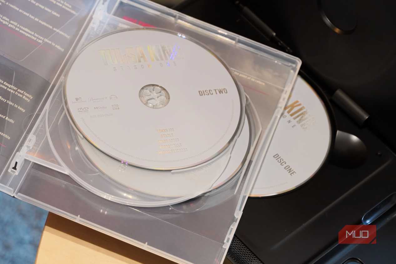 A pile of DVD discs on a player.