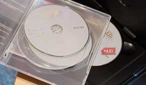 A pile of DVD discs on a player.