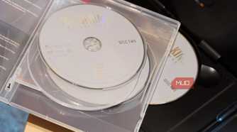 A pile of DVD discs on a player.
