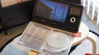 A DVD playing in front of a case.
