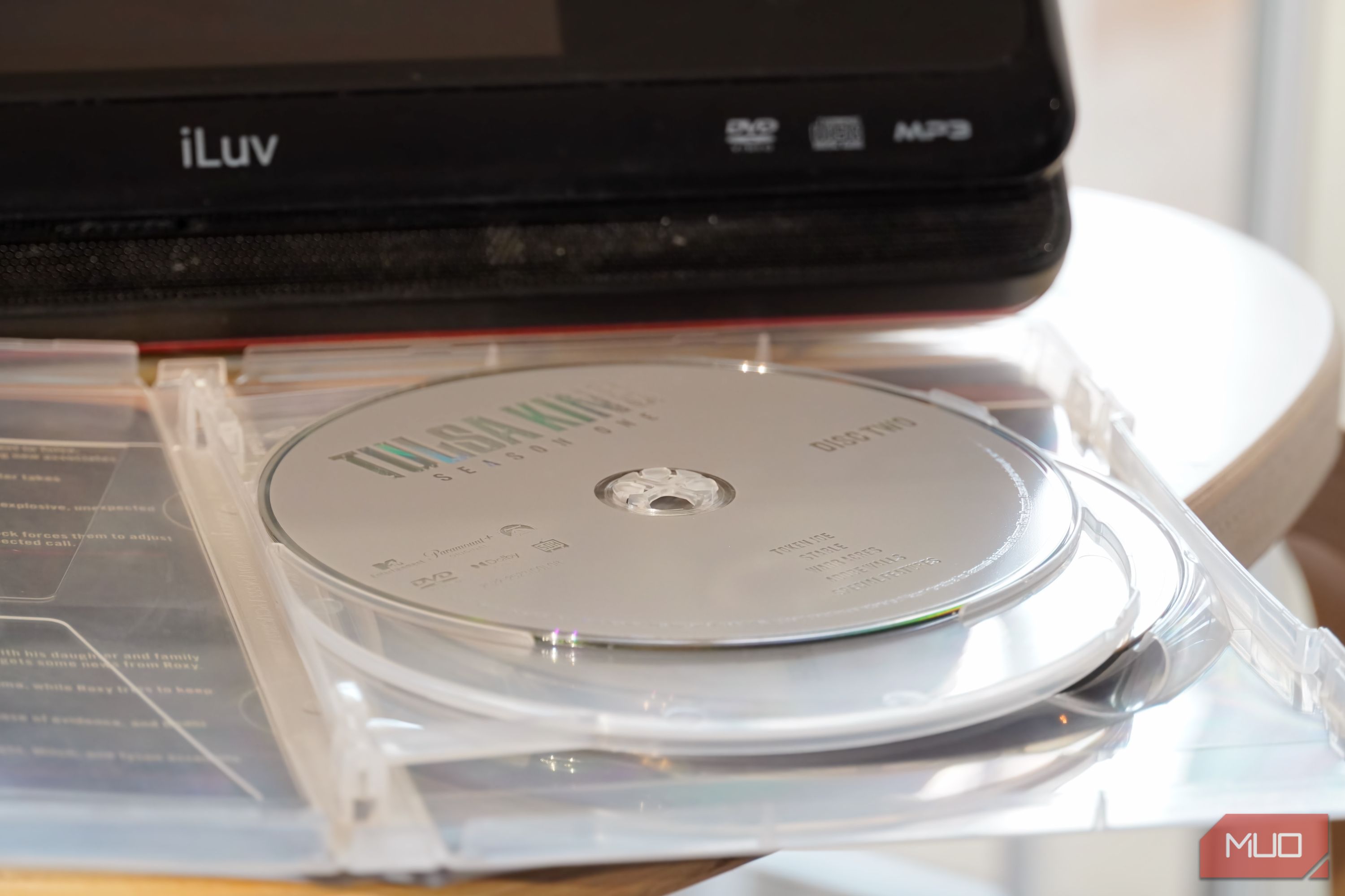 A DVD disc in front of a portable player.
