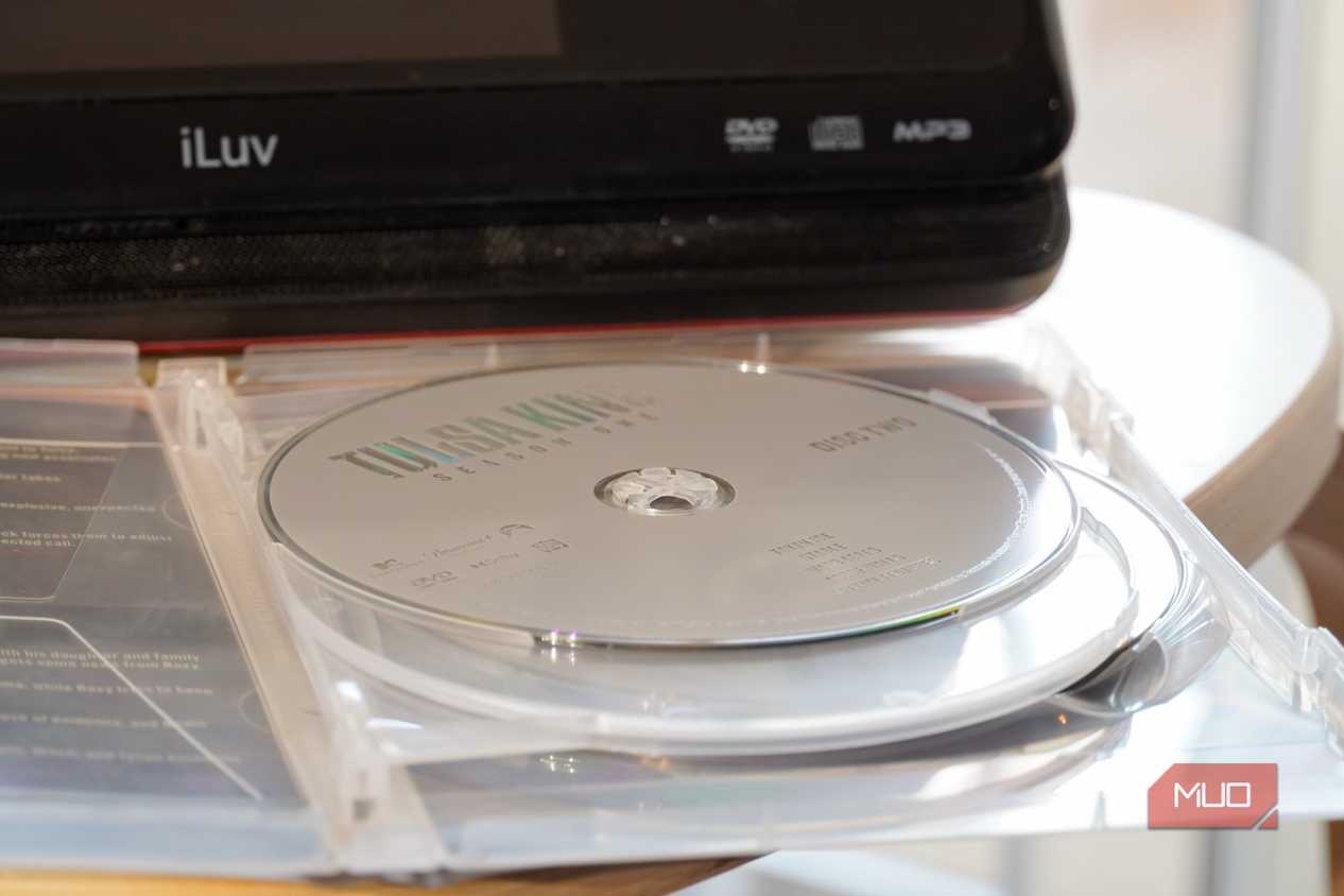 A DVD disc in front of a portable player.